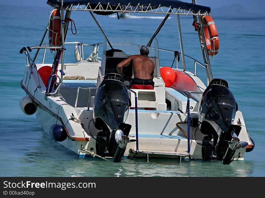 Speedy boat is ready for racing . The blue water is on the background .