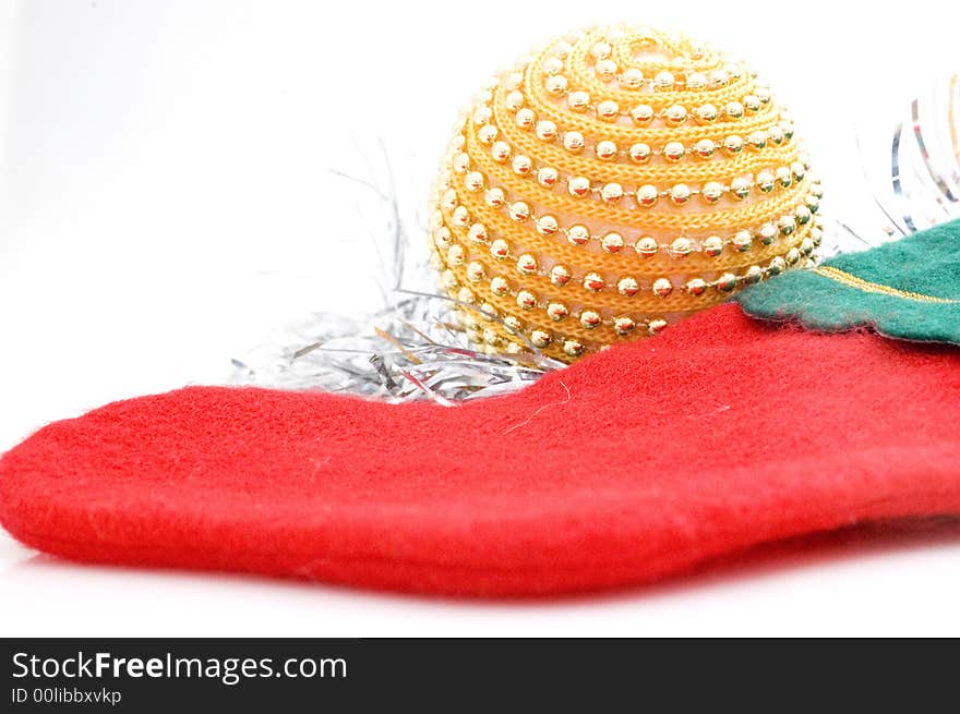 Photograph of Christmas stocking on white background with Christmas tree decoration.