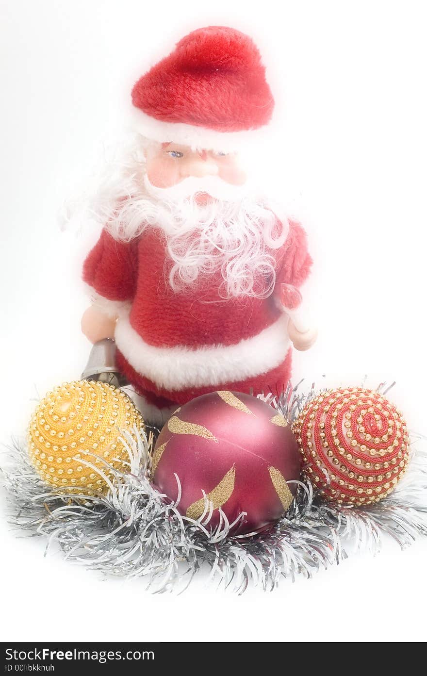 Santa Claus toy on white background with Christmas tree decorations.