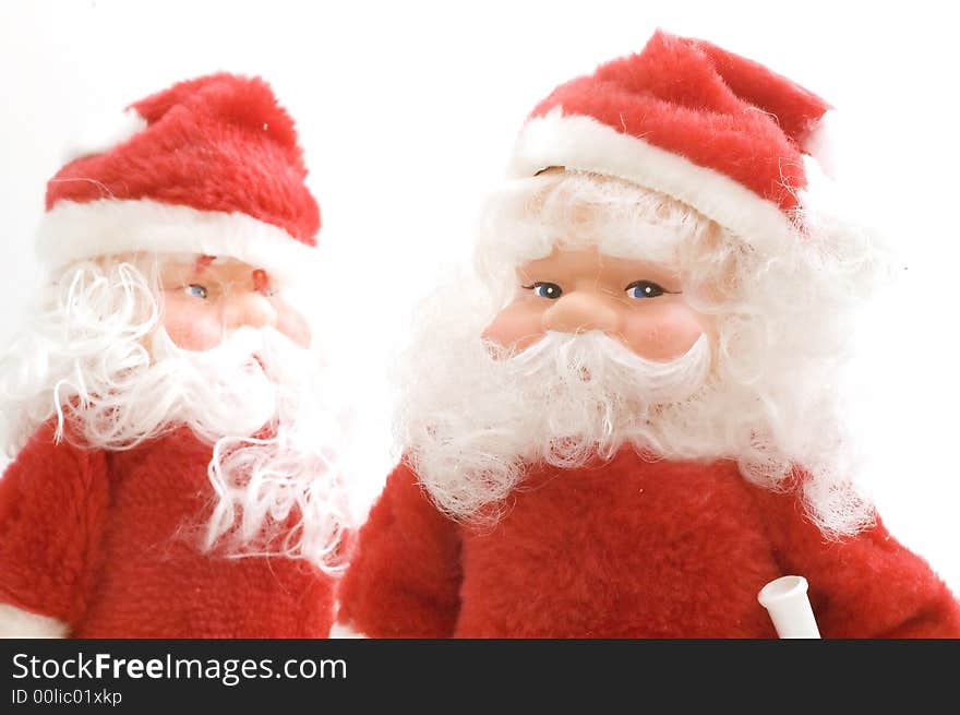 Two Santa claus toy on white background.