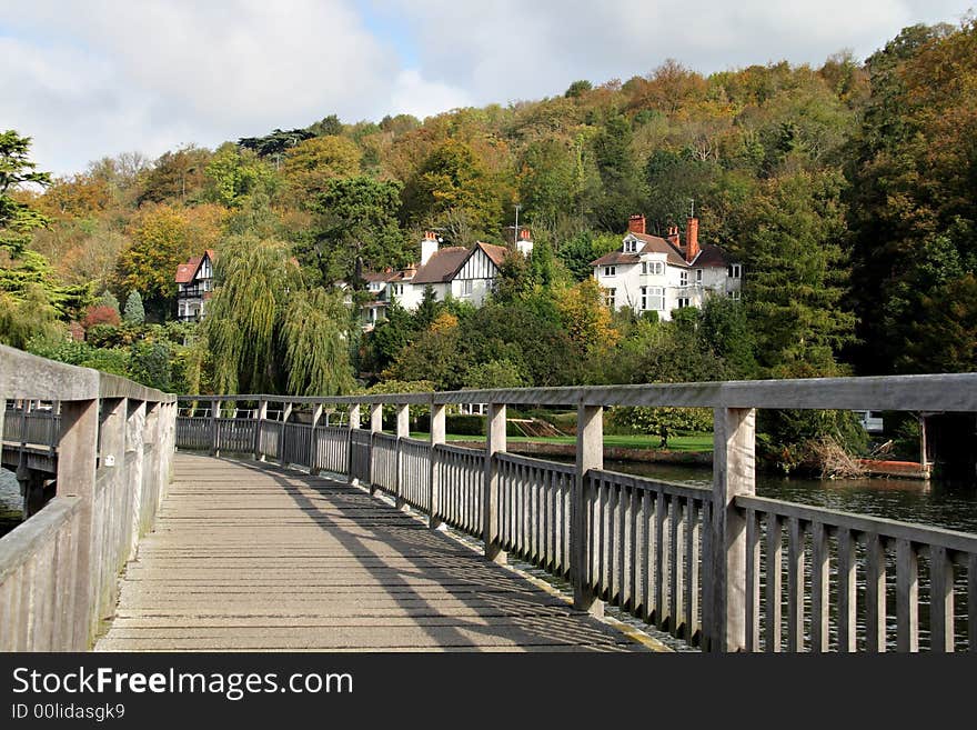 Early Autumn on a wooden footbridge over the River Thames. Early Autumn on a wooden footbridge over the River Thames