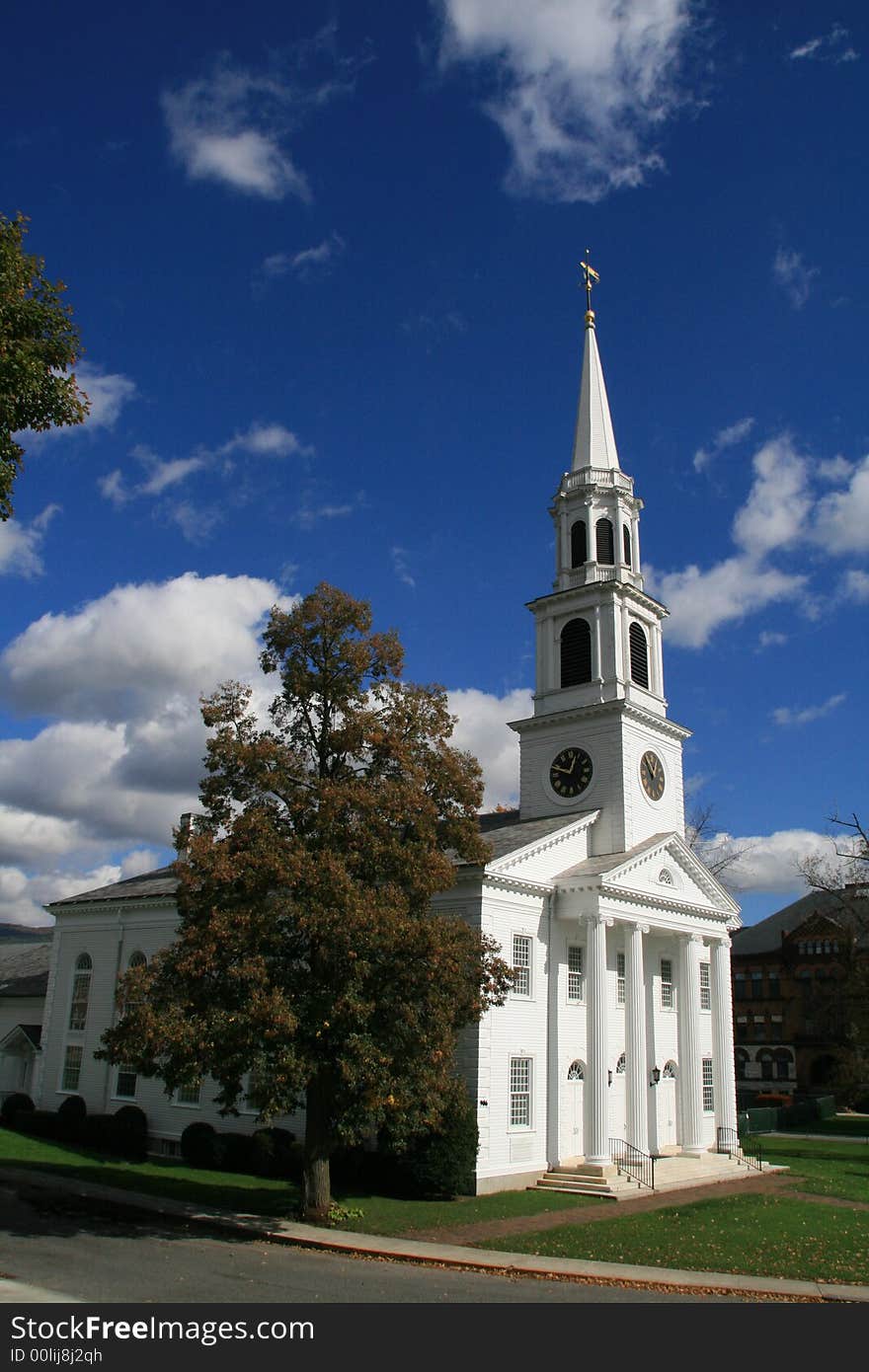 White church on a fall day in new england with blue skies and clouds. White church on a fall day in new england with blue skies and clouds