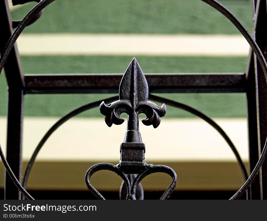 A shot of a fence with a iron spike and lines and Shapes.