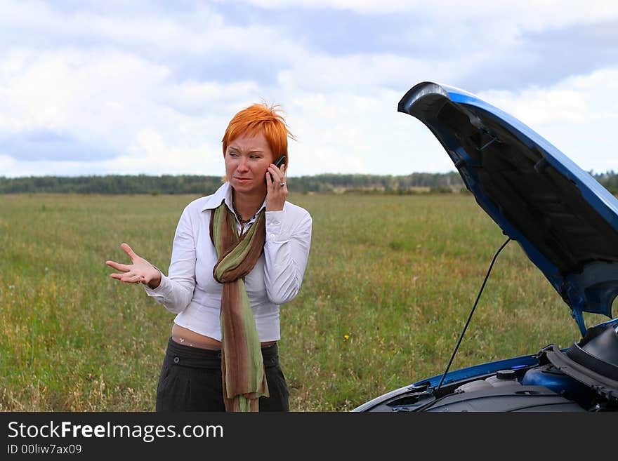 Young woman with broken car.