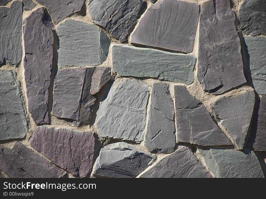 A thick textured slate or shale rock wall or path in a crazy random pattern. A thick textured slate or shale rock wall or path in a crazy random pattern