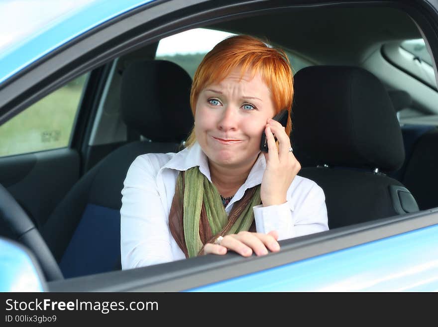 Woman with phone incar.