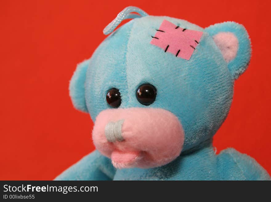 Blue teddy bear against dark orange background. Blue teddy bear against dark orange background