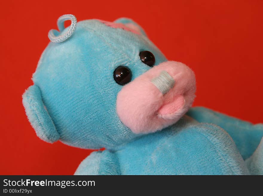 Blue teddy bear against dark orange background. Blue teddy bear against dark orange background