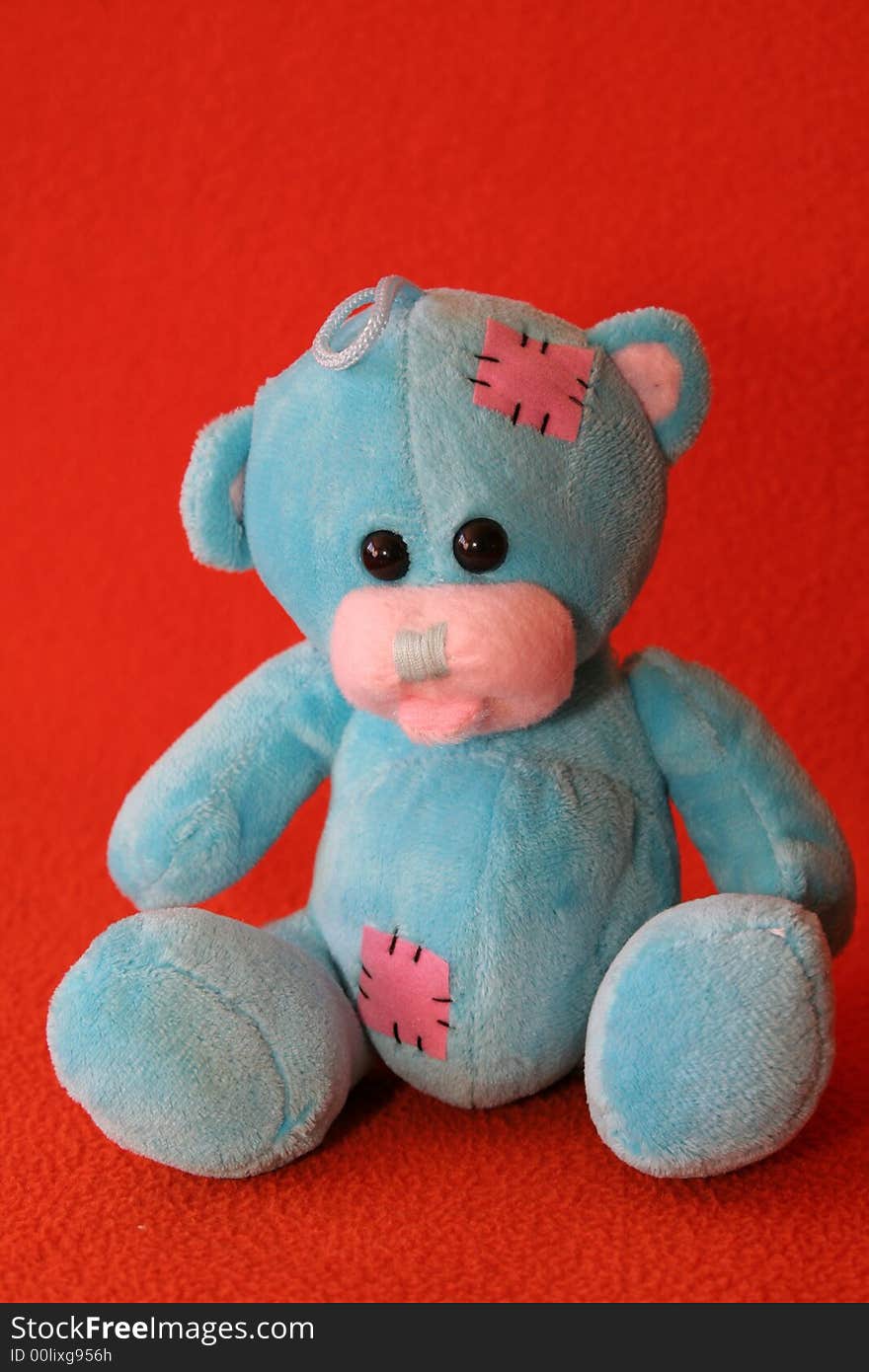 Blue teddy bear against dark orange background. Blue teddy bear against dark orange background