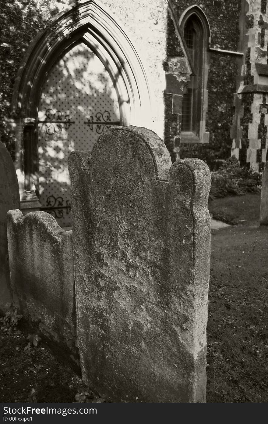Ancient gravestones in medieval churchyard in black and white. Ancient gravestones in medieval churchyard in black and white