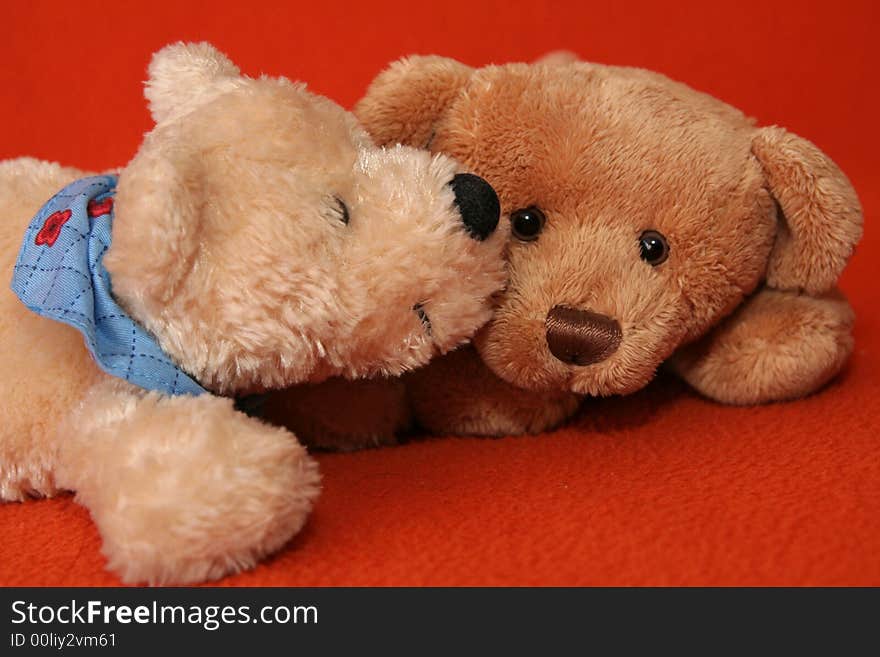 Teddy bears against dark orange background. Teddy bears against dark orange background