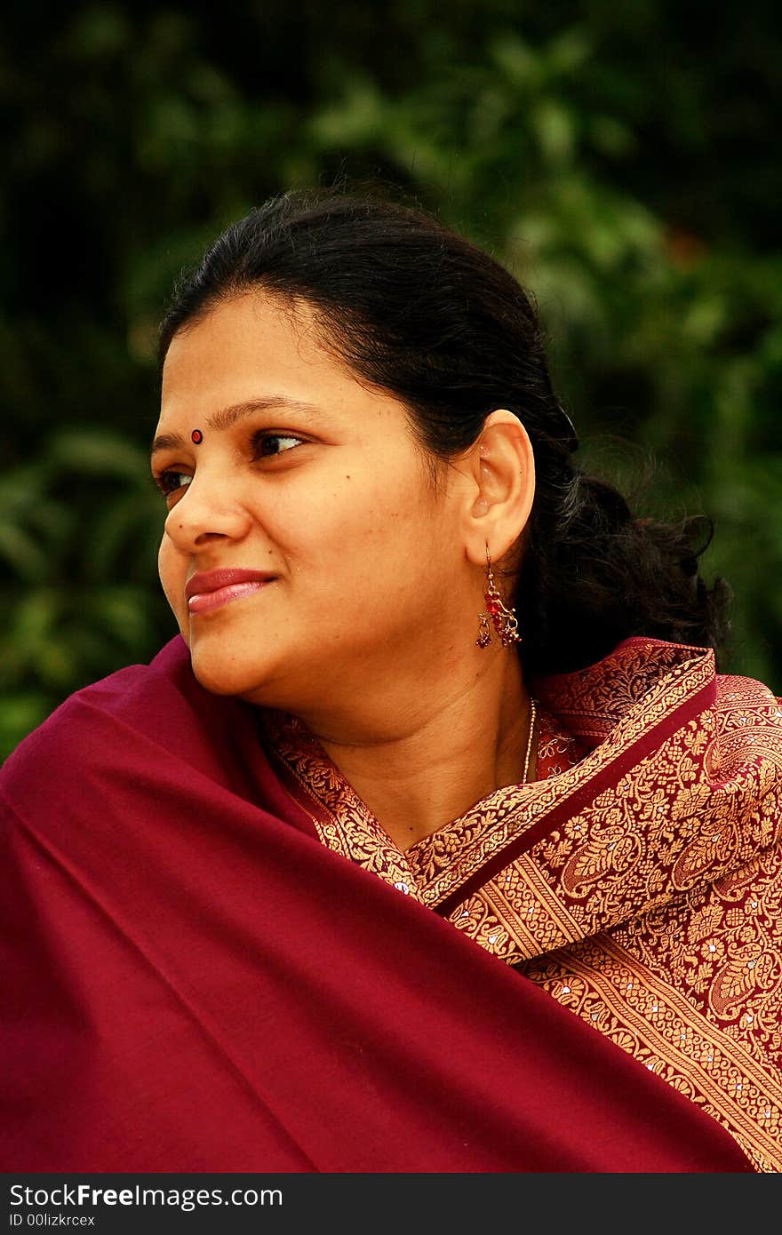 An Indian woman in a calm and relaxed mood showing contented state of mind. An Indian woman in a calm and relaxed mood showing contented state of mind.