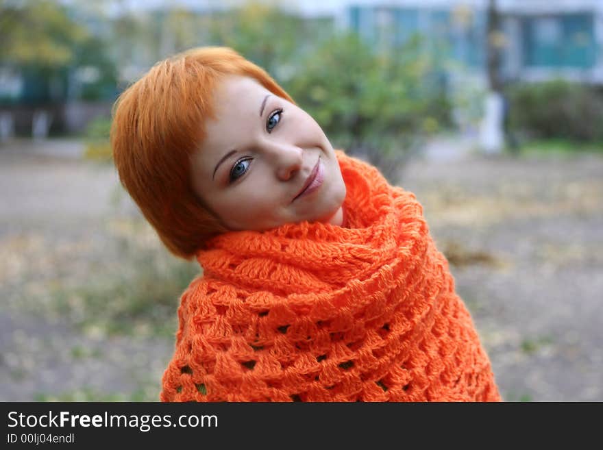 Young red-haired woman in red scarf