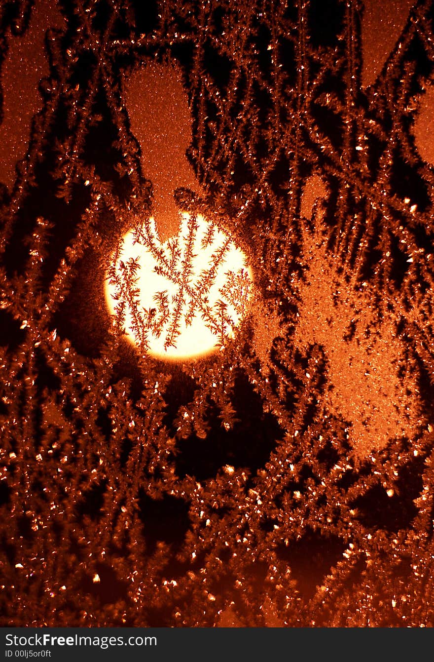 Full moon and frosty pattern on windowpane