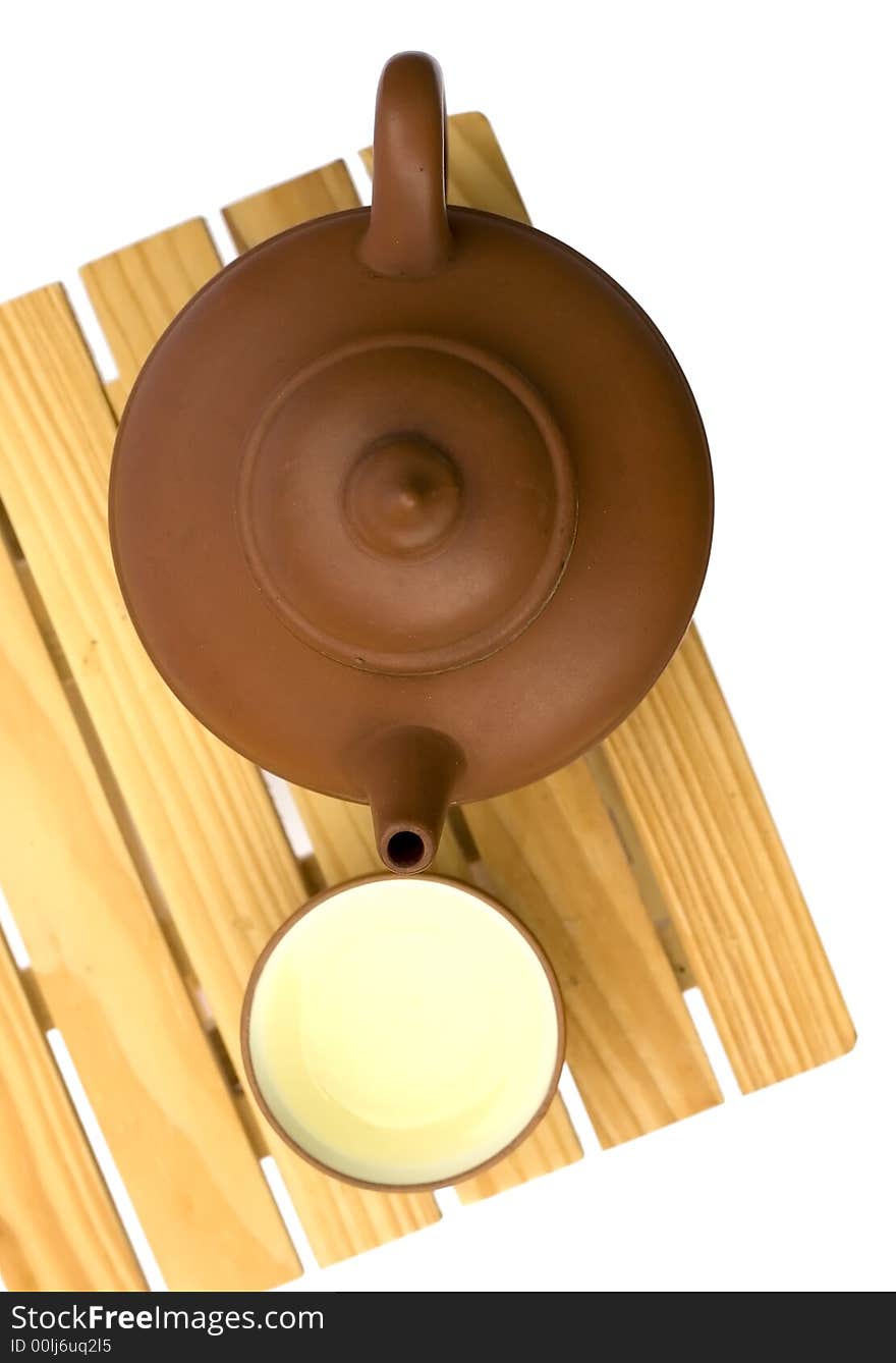 Teapot and teacup on a small wooden table