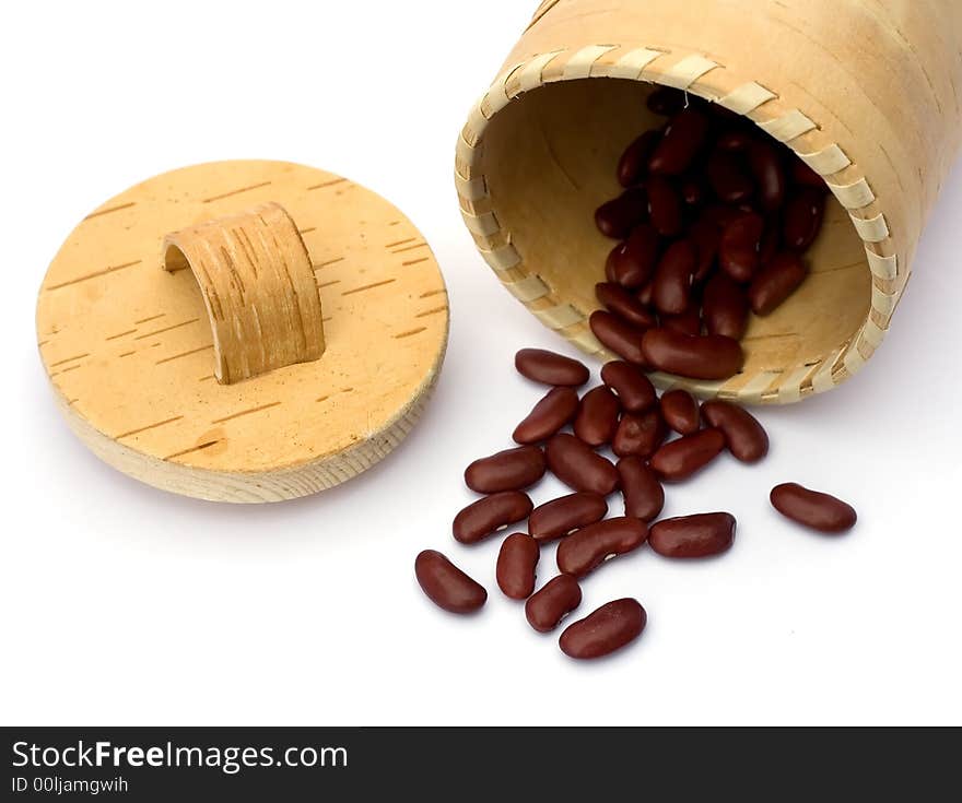 Kidney beans spilling out over a white background