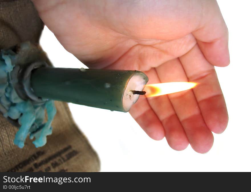 Woman's hand holding a candle on white background