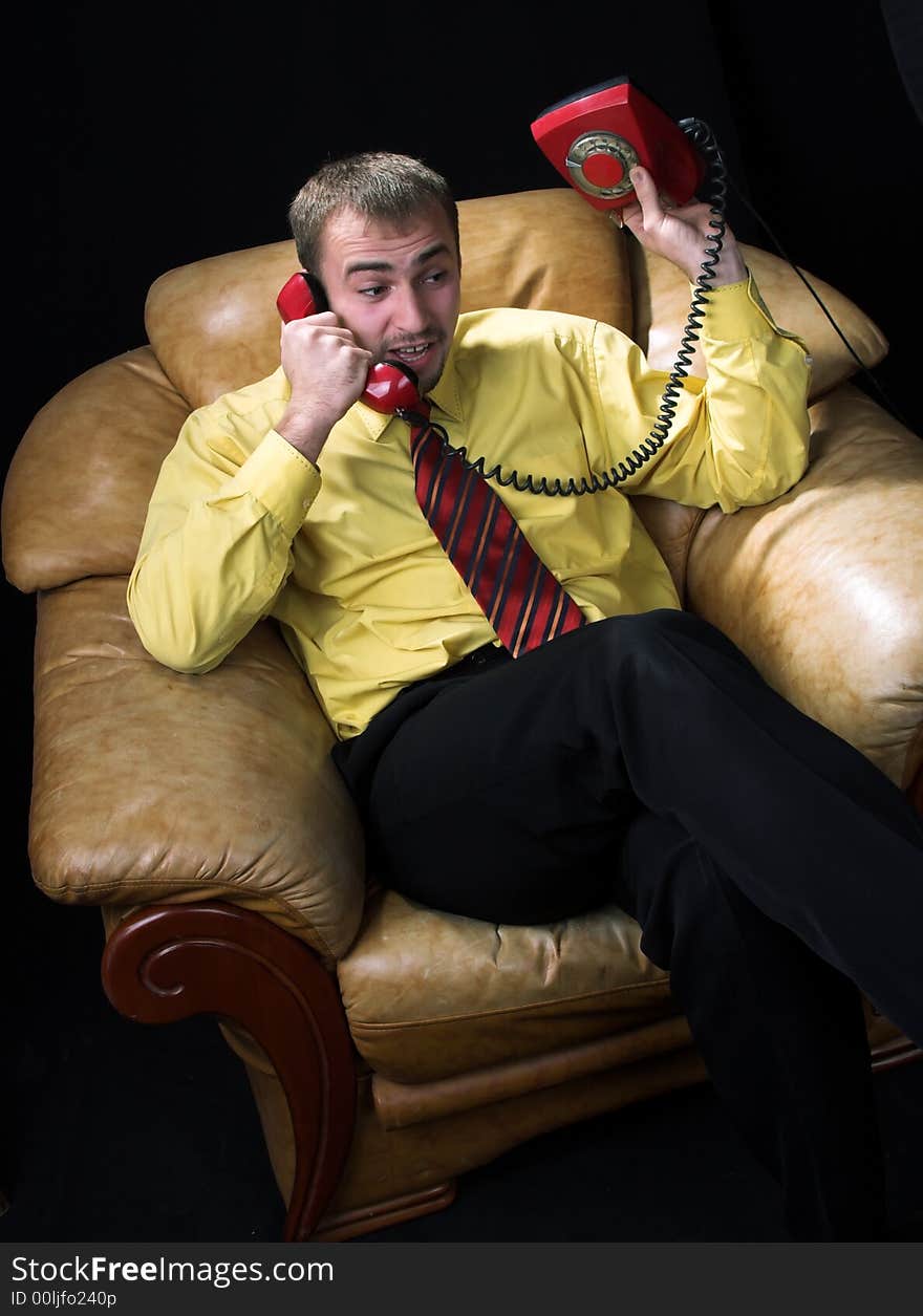 The man negotiates by the phone. The man negotiates by the phone