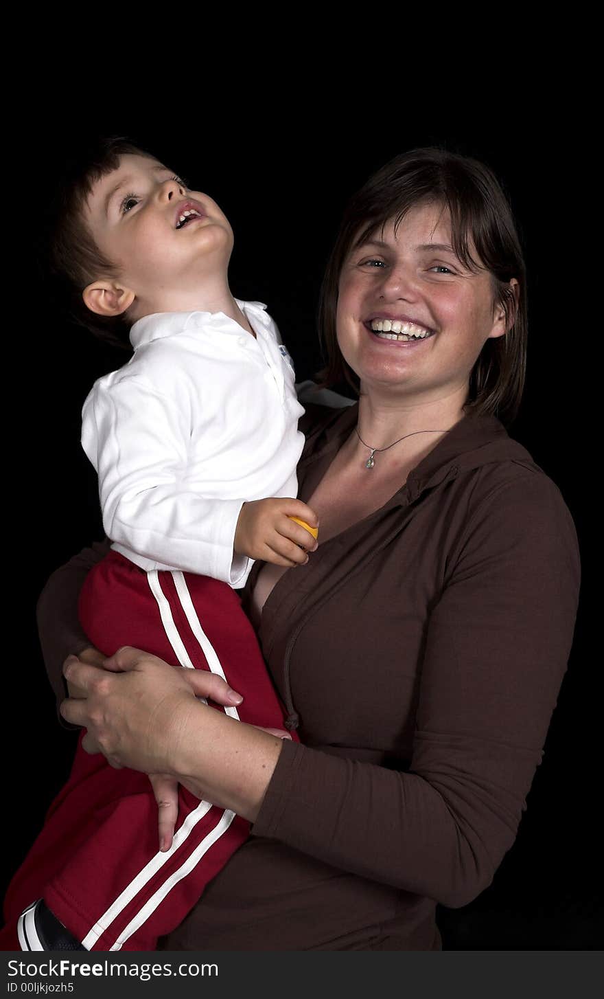 Mother ans son playing over black backdrop