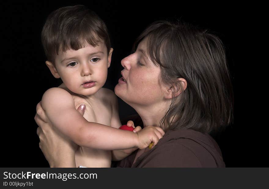 Mother ans son playing over black backdrop