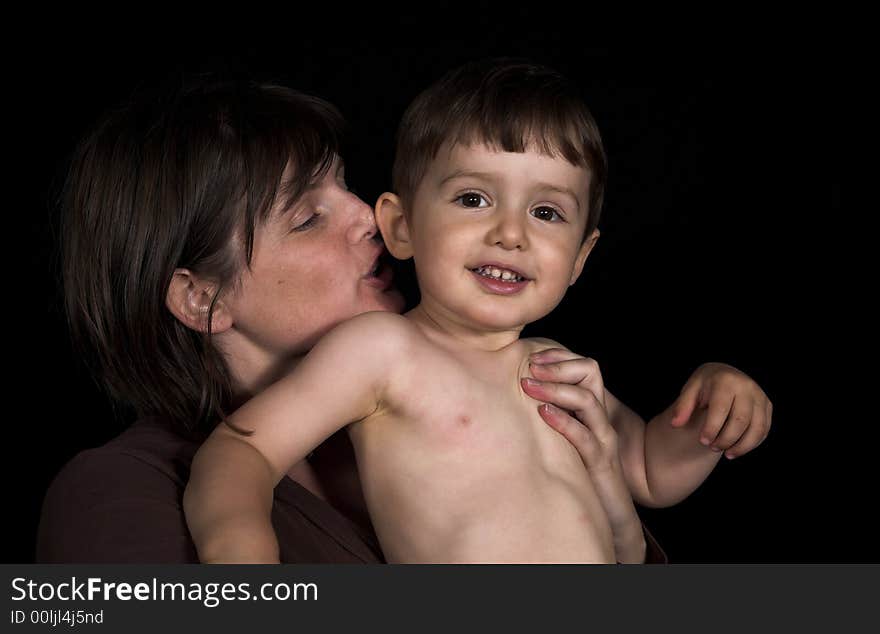 Mother ans son playing over black backdrop