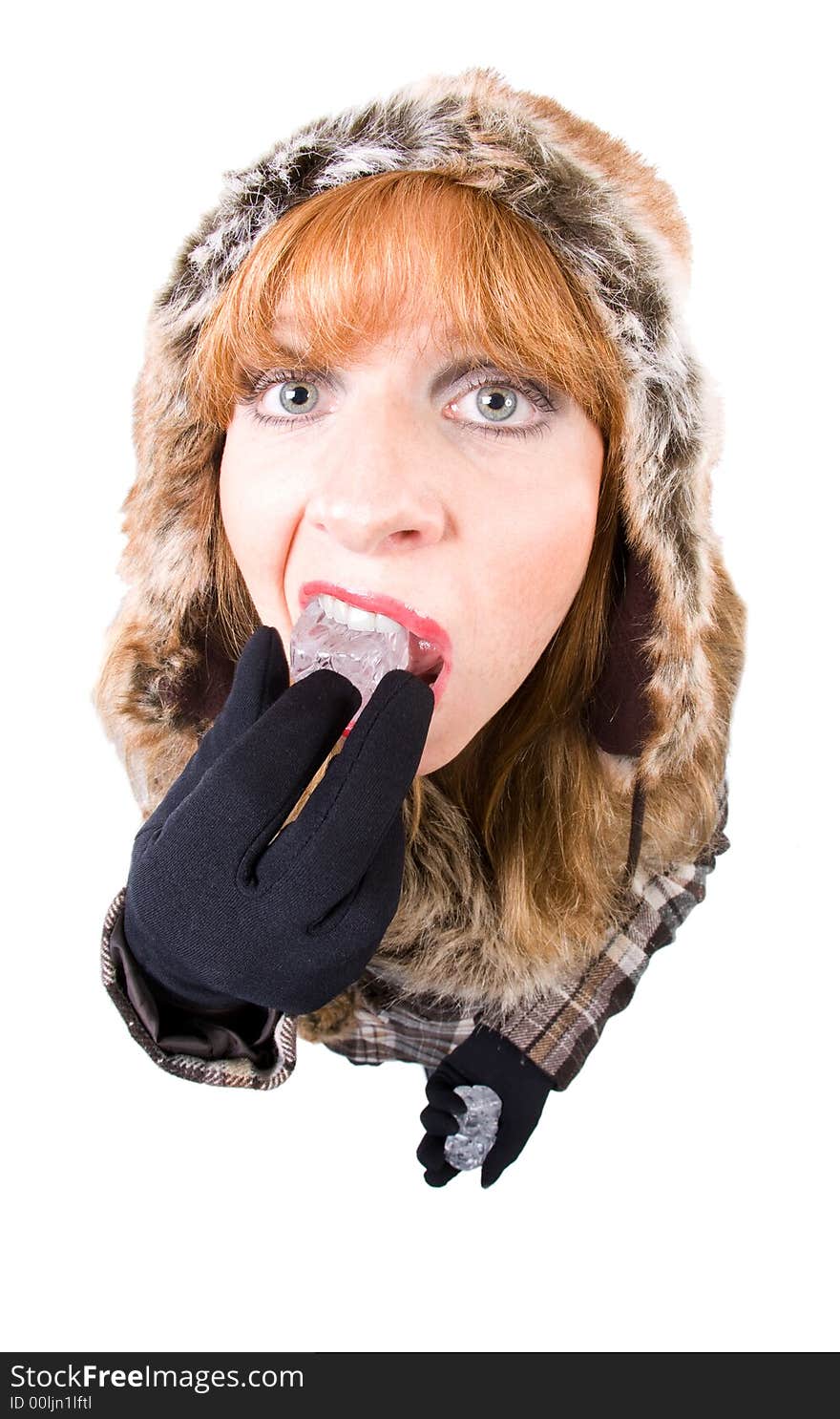 Woman in winter-clothing sucking an icecube. Overstated Fisheye-Effect. Isolated on white. Woman in winter-clothing sucking an icecube. Overstated Fisheye-Effect. Isolated on white.