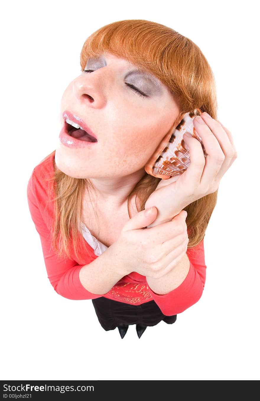 Woman holding a shell on her ear and dreaming for the next holidays. Overstated Fisheye-Effect. Isolated on white. Woman holding a shell on her ear and dreaming for the next holidays. Overstated Fisheye-Effect. Isolated on white.