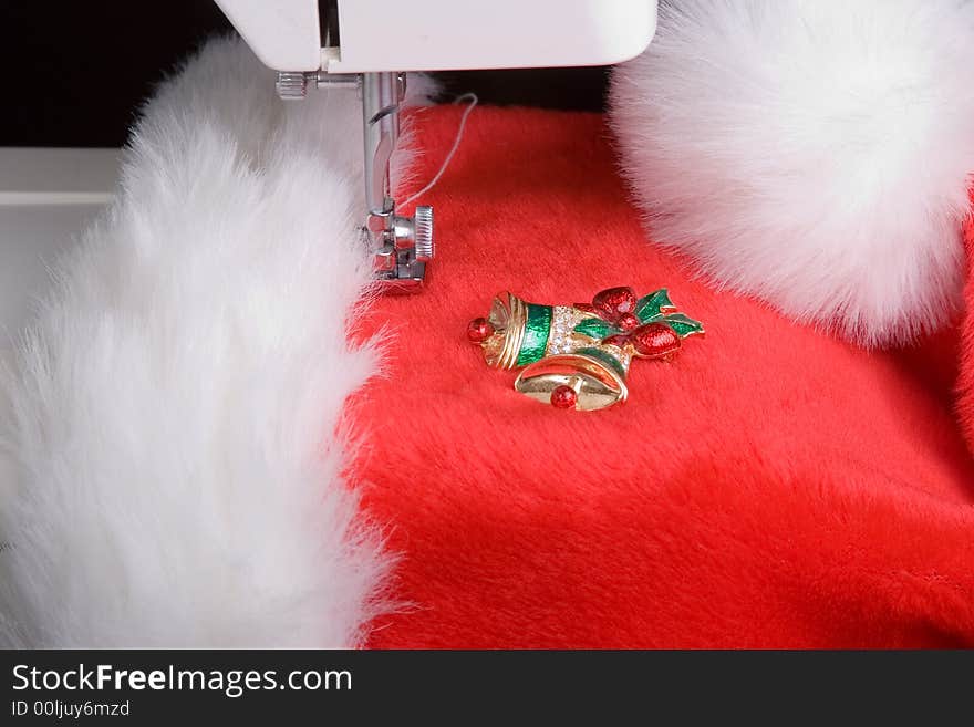 Close up capture of a sewing machine foot and Santa's hat. Close up capture of a sewing machine foot and Santa's hat.