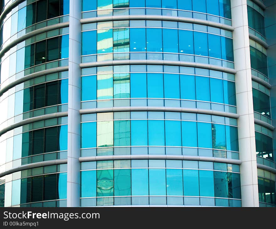 A circular facade of a modern office building in busy metropolis