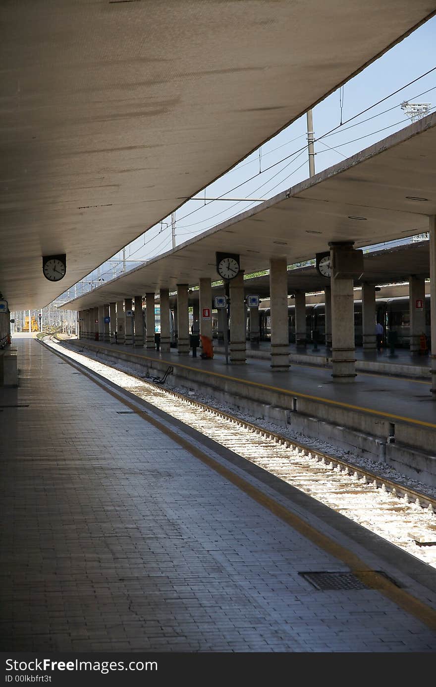 Emtpy train station in Italy with train tracks illuminated