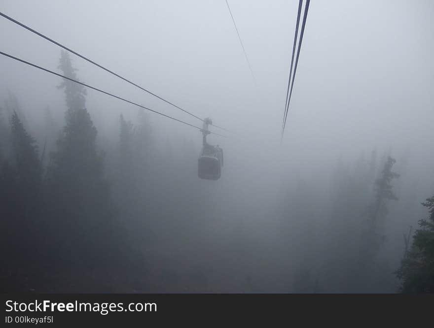 Gondola approaching in dense fog above Banff resort, Canada. Gondola approaching in dense fog above Banff resort, Canada