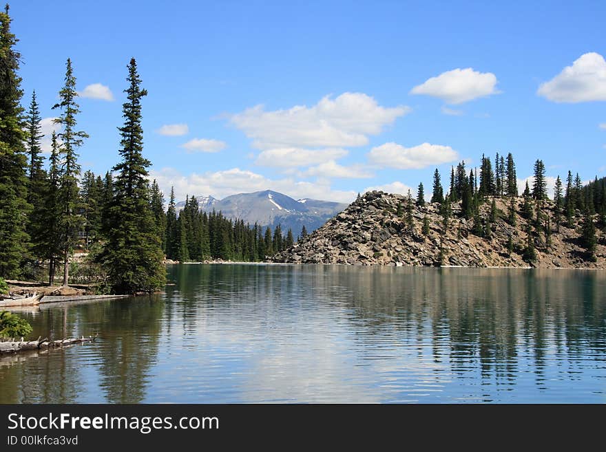 Reflections on calm brilliant blue mountain lake. Reflections on calm brilliant blue mountain lake.