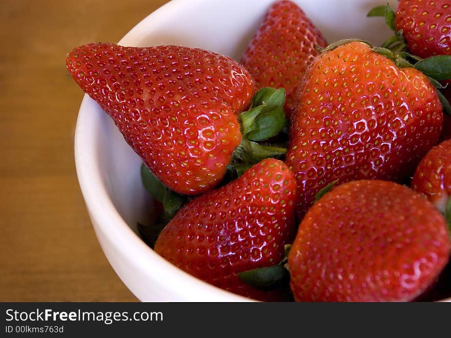 A large bowl of rich ripe red and juicy strawberries. A large bowl of rich ripe red and juicy strawberries