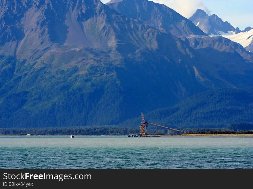 Alaska mountains with snow and industrial equipment.