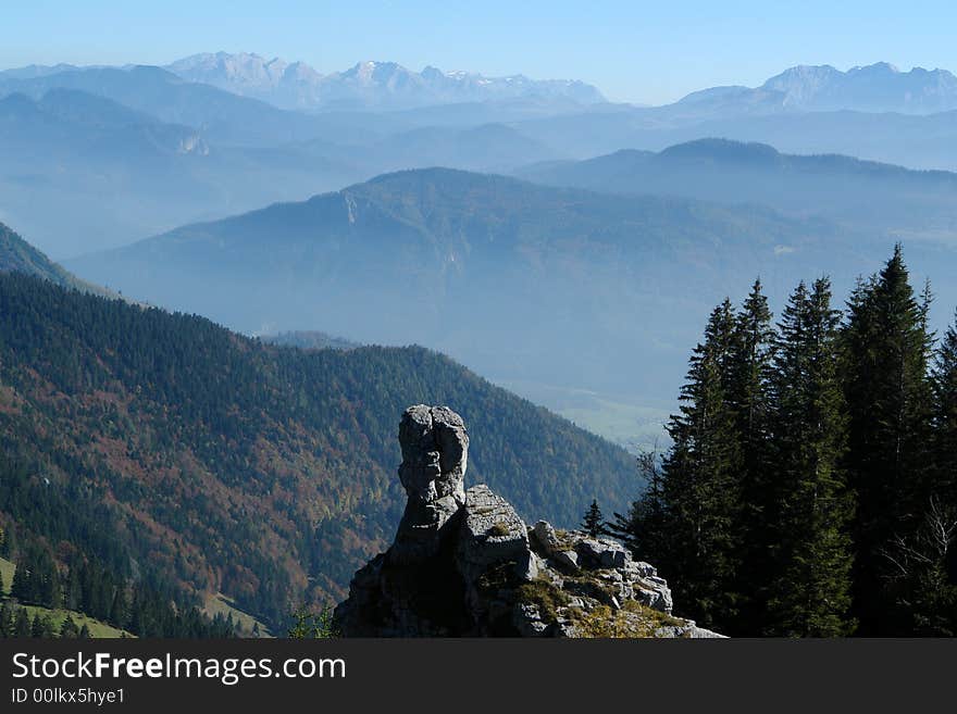 Rock on the Backgrounf of Mountains. Alpes, Bavaria, Germany . Sight from the Kampenwand Mountain ( Height 1665 m ).High Alpes in Austria is in the distance.October 2007 . Rock on the Backgrounf of Mountains. Alpes, Bavaria, Germany . Sight from the Kampenwand Mountain ( Height 1665 m ).High Alpes in Austria is in the distance.October 2007 .