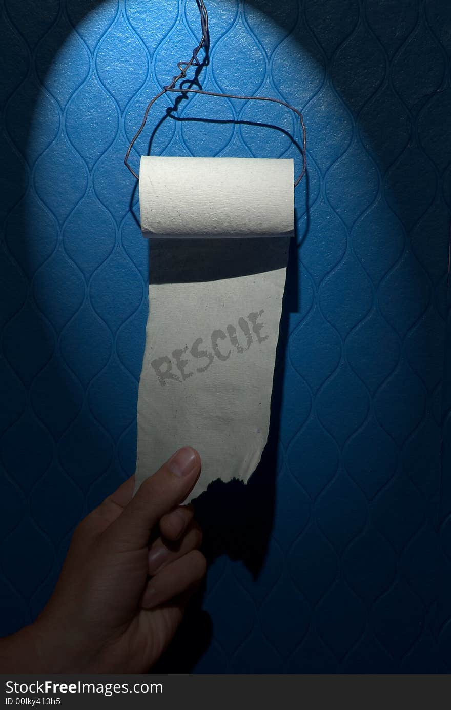 Cheap toilet paper roll with rescue inscription on the blue wall in the public restroom.