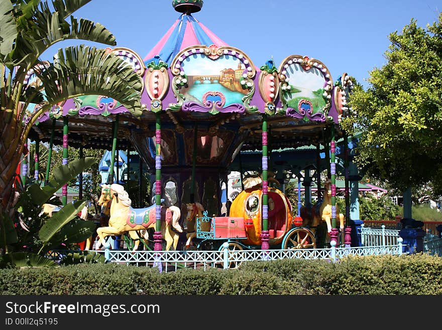 A merry-go-round hoarse and carriage ride at a carnival. A merry-go-round hoarse and carriage ride at a carnival