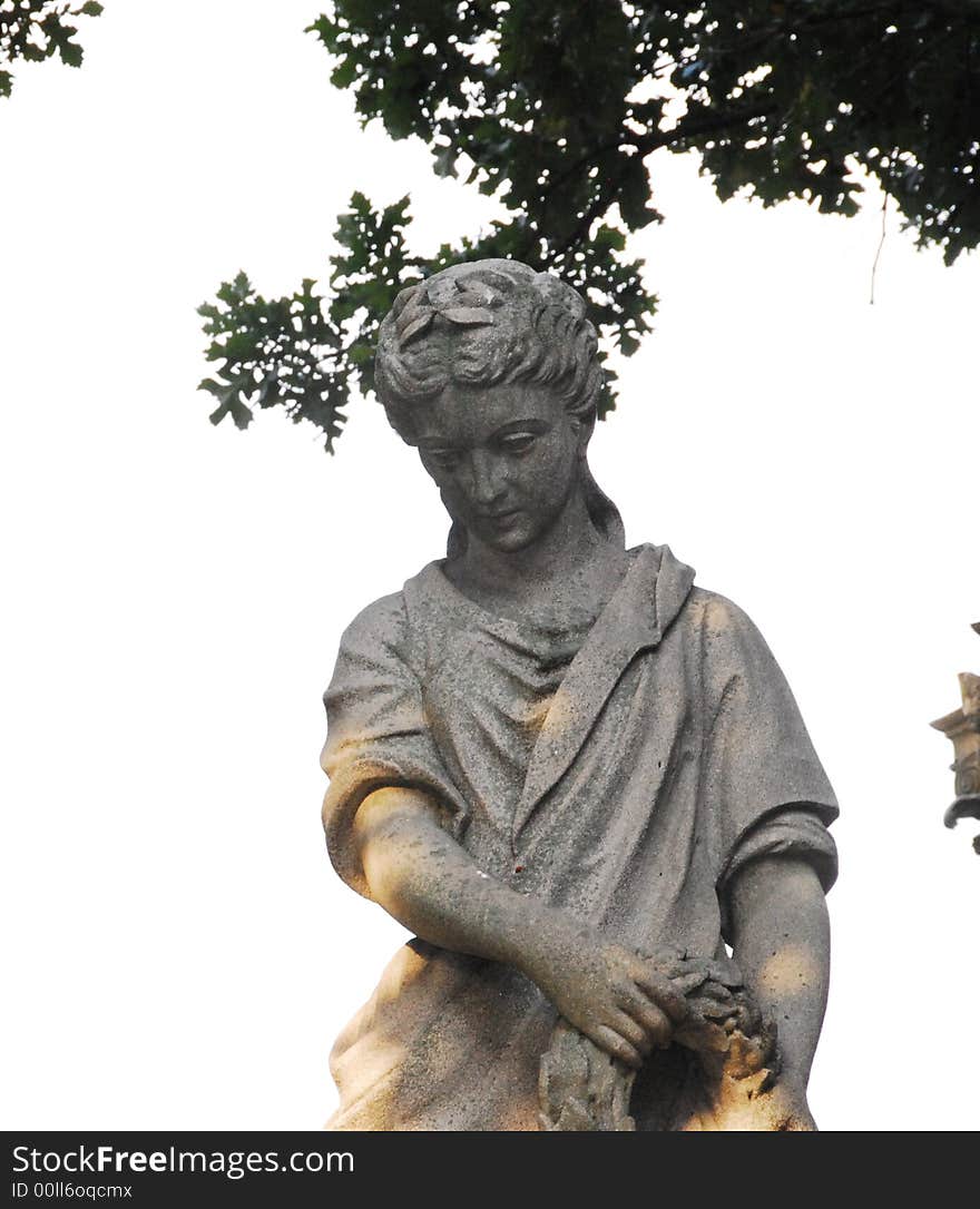 Cemetery monument weathered stone statue of a  woman. Cemetery monument weathered stone statue of a  woman