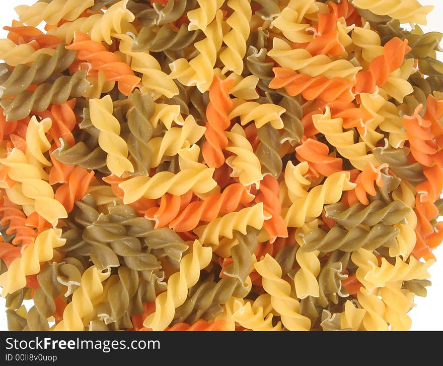 A bed of tricolor fusilli pasta