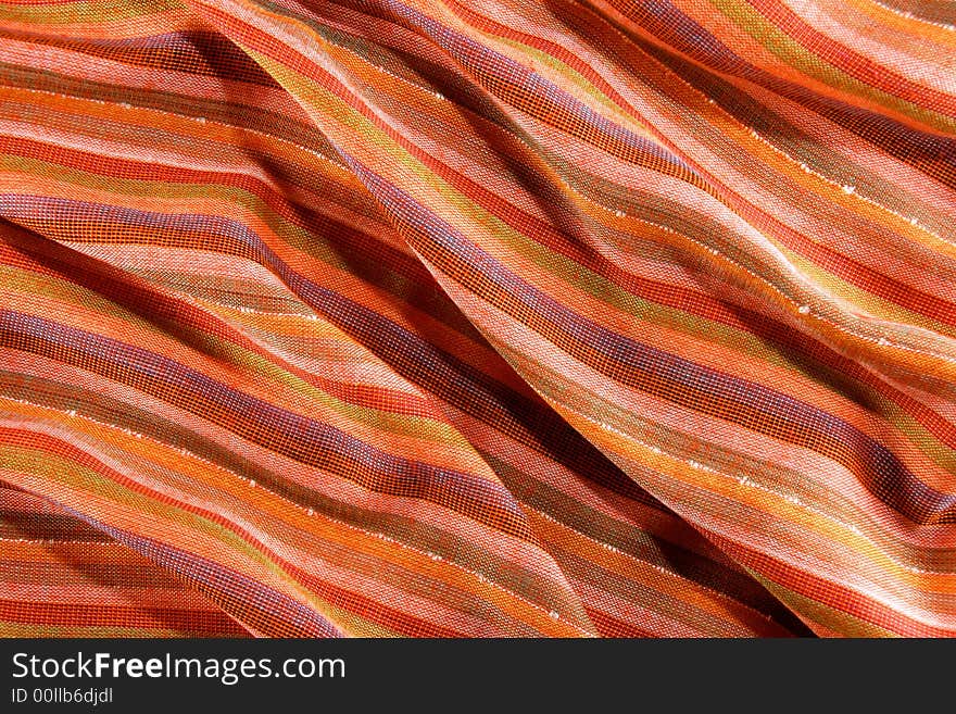 Colorful textile close-up. Scarf background texture. Warm colors. Colorful textile close-up. Scarf background texture. Warm colors.