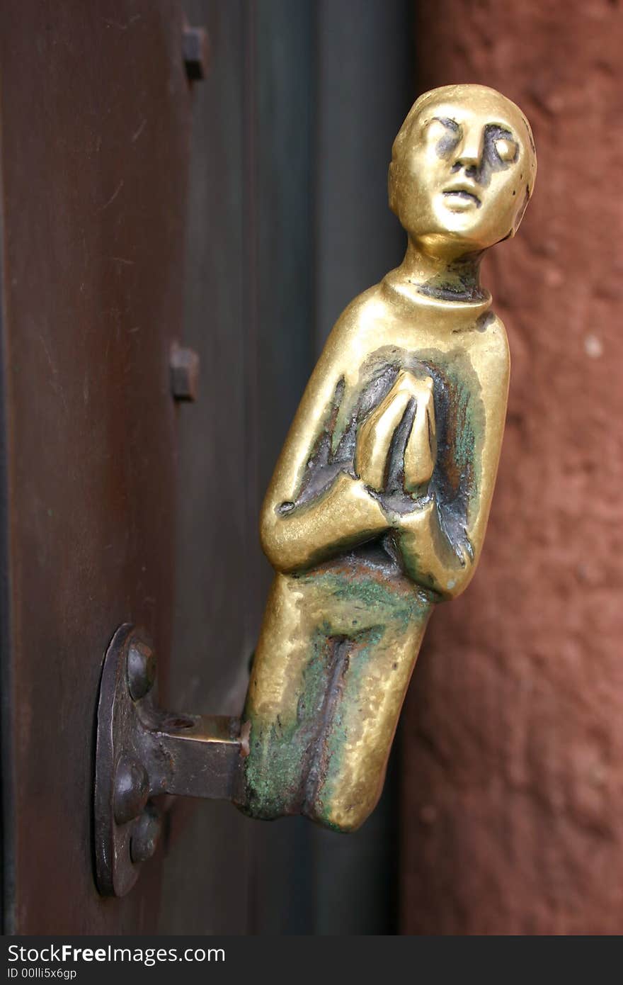 Old metal door knob of a church praying. Old metal door knob of a church praying