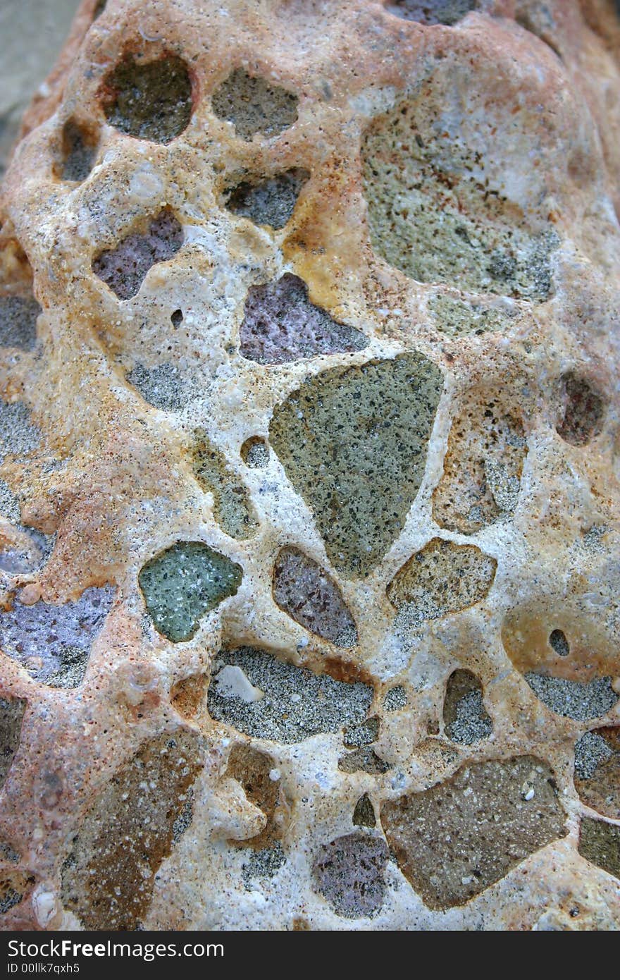 Beautiful texture of a washed beach rock with purple and green colors. Beautiful texture of a washed beach rock with purple and green colors