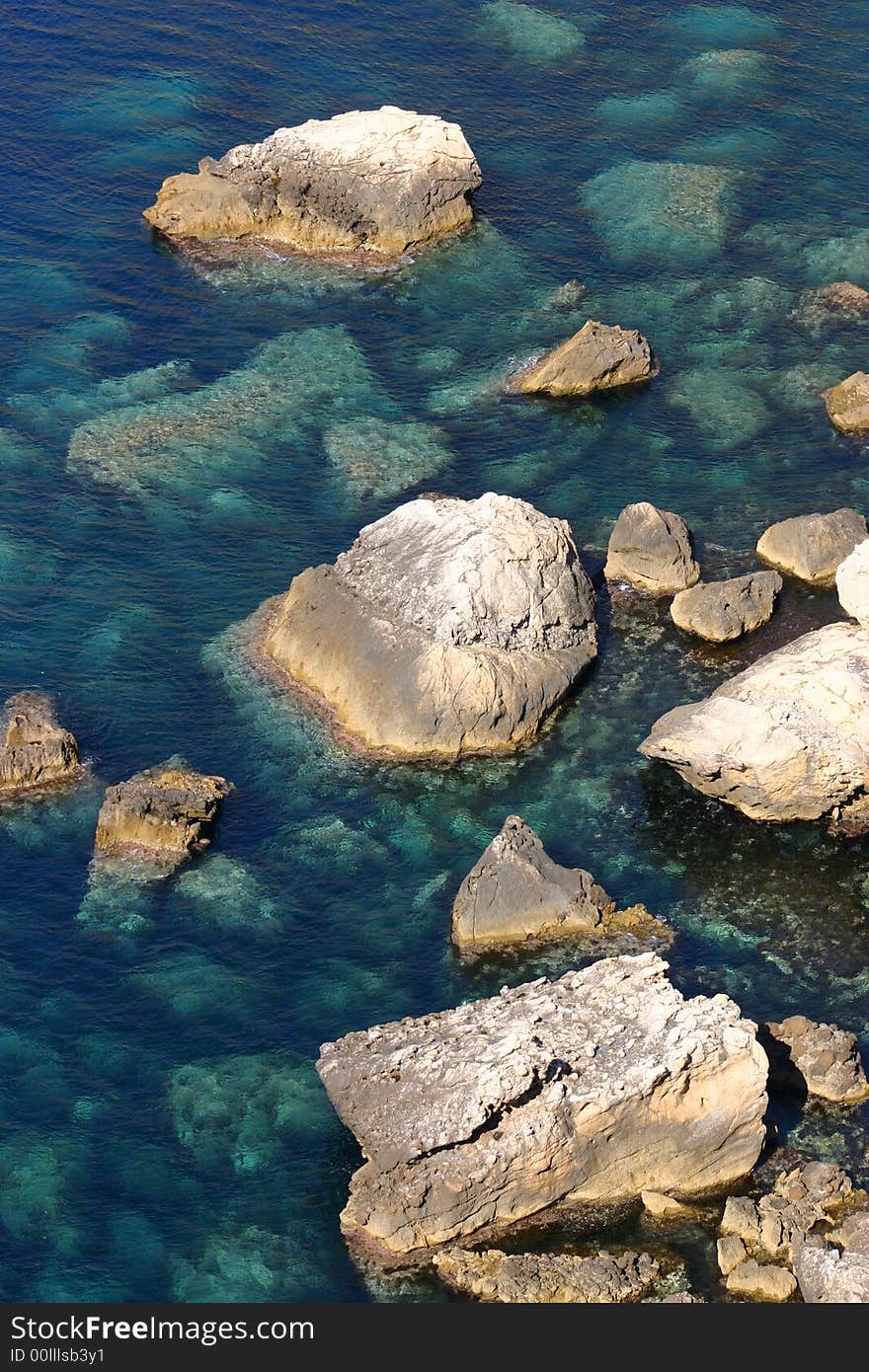 Beautiful background with turquoise water at a rocky coastline. Beautiful background with turquoise water at a rocky coastline