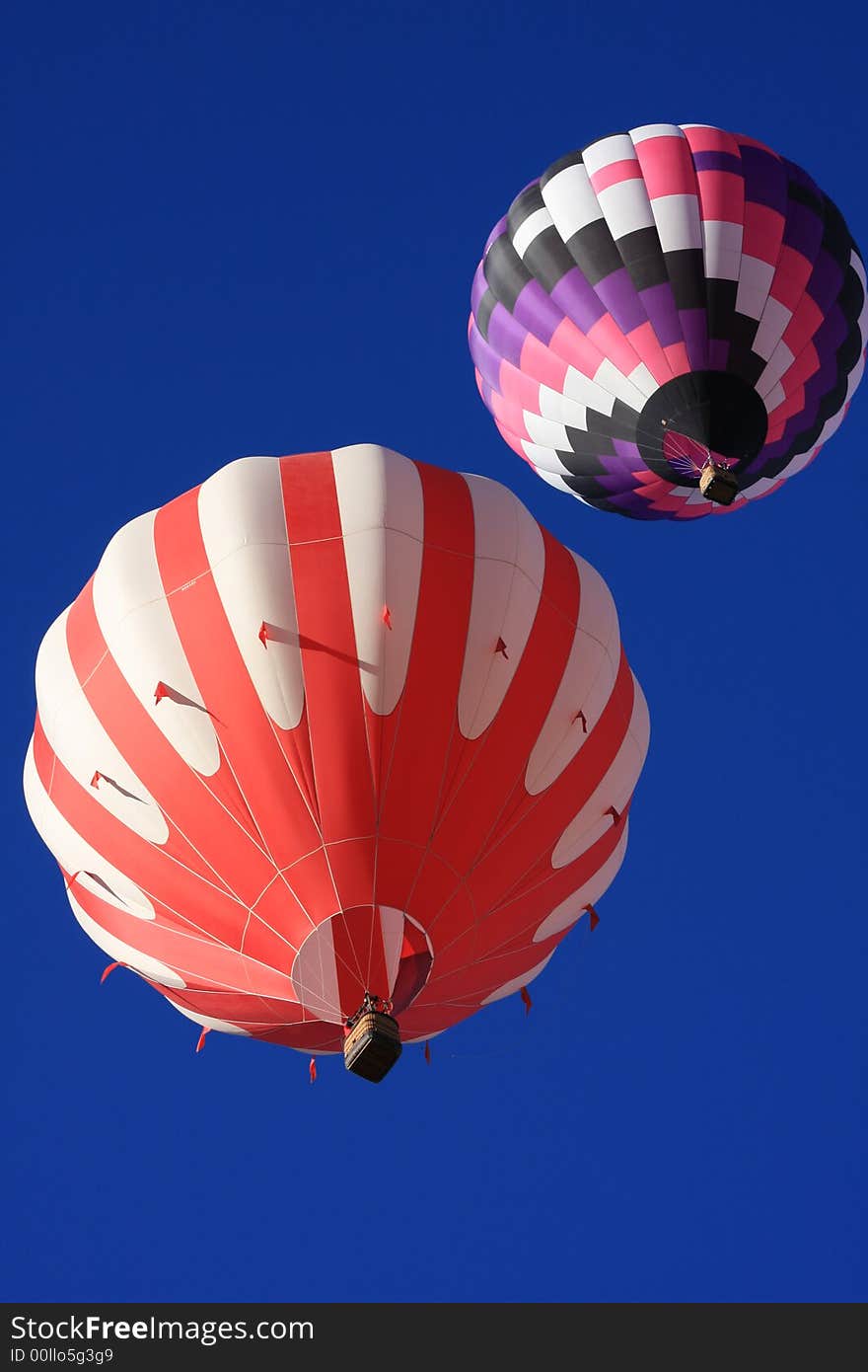 Two colorful hot air balloons taken from angle almost directly overhead. Two colorful hot air balloons taken from angle almost directly overhead