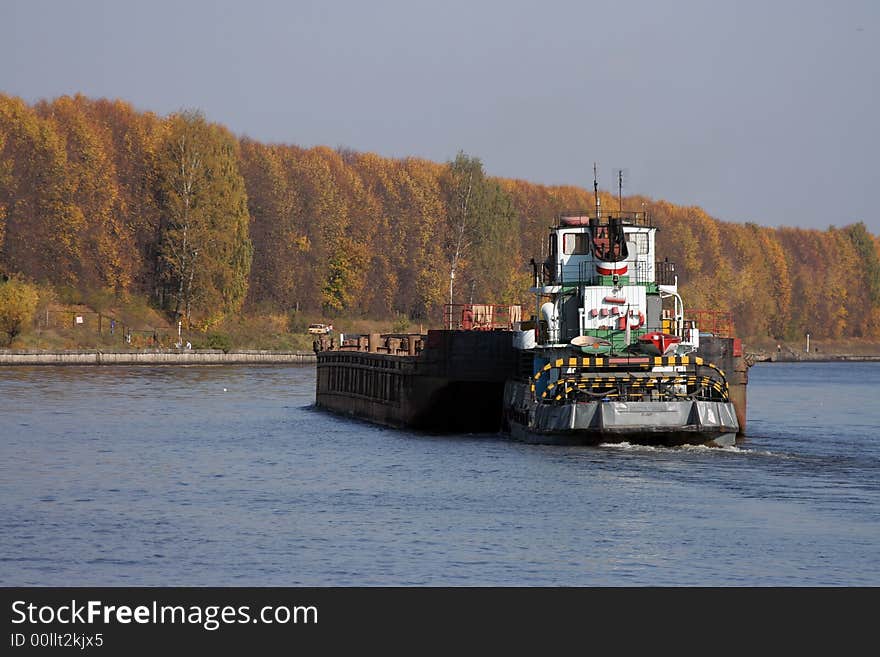 Barge pushed by towboat on the river.