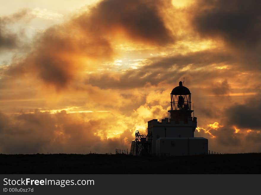 Birsay Lighthouse, Orkney, in silhouette at sunset. Birsay Lighthouse, Orkney, in silhouette at sunset