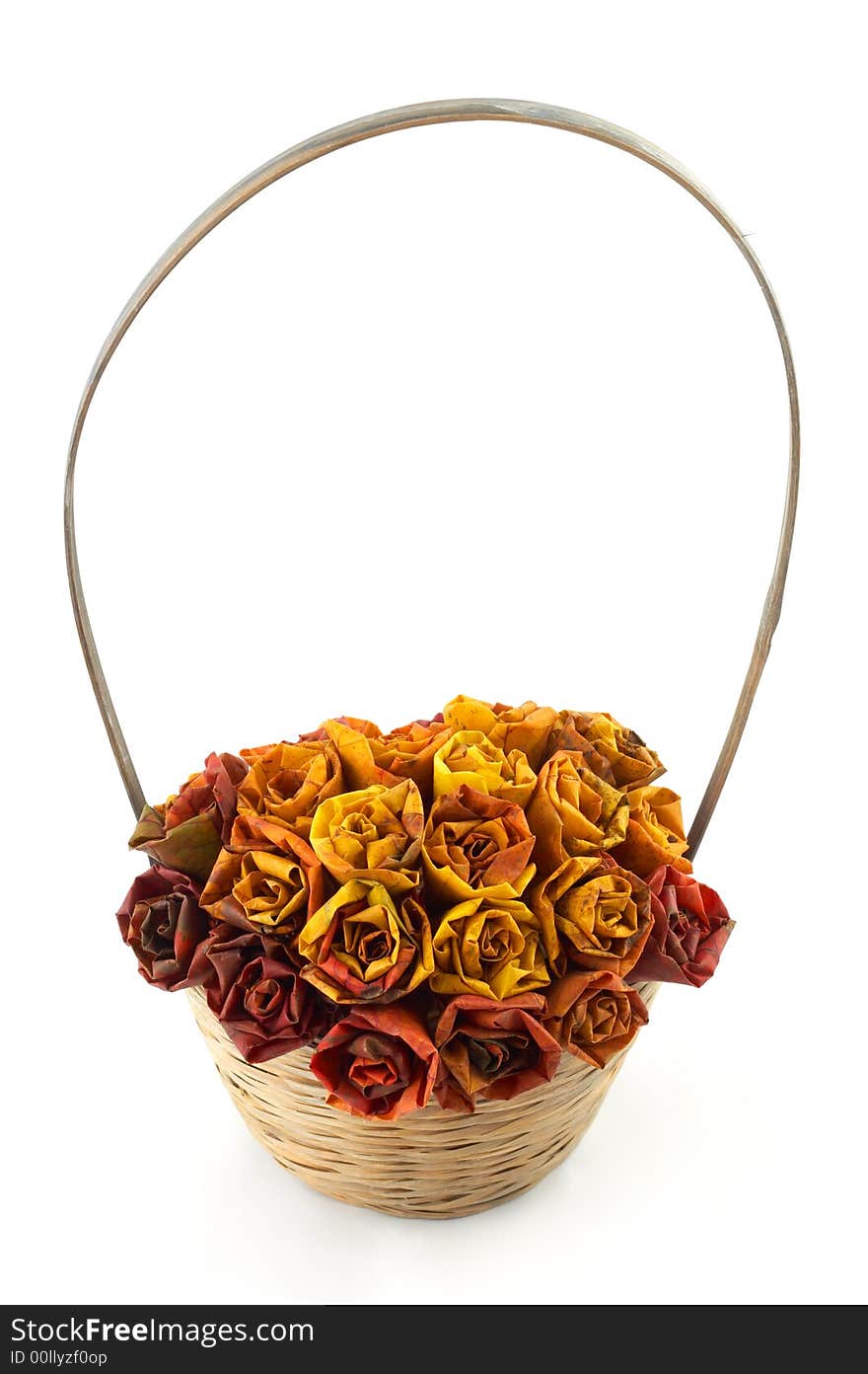 A basket with some roses made of maple leaves in it. A basket with some roses made of maple leaves in it