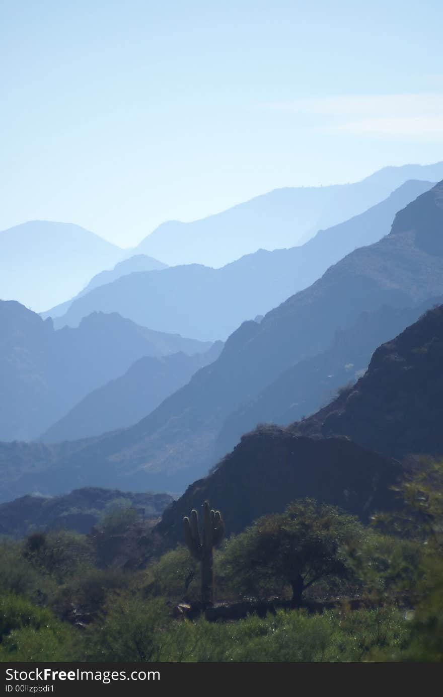 Many mountain shadows in a clear day