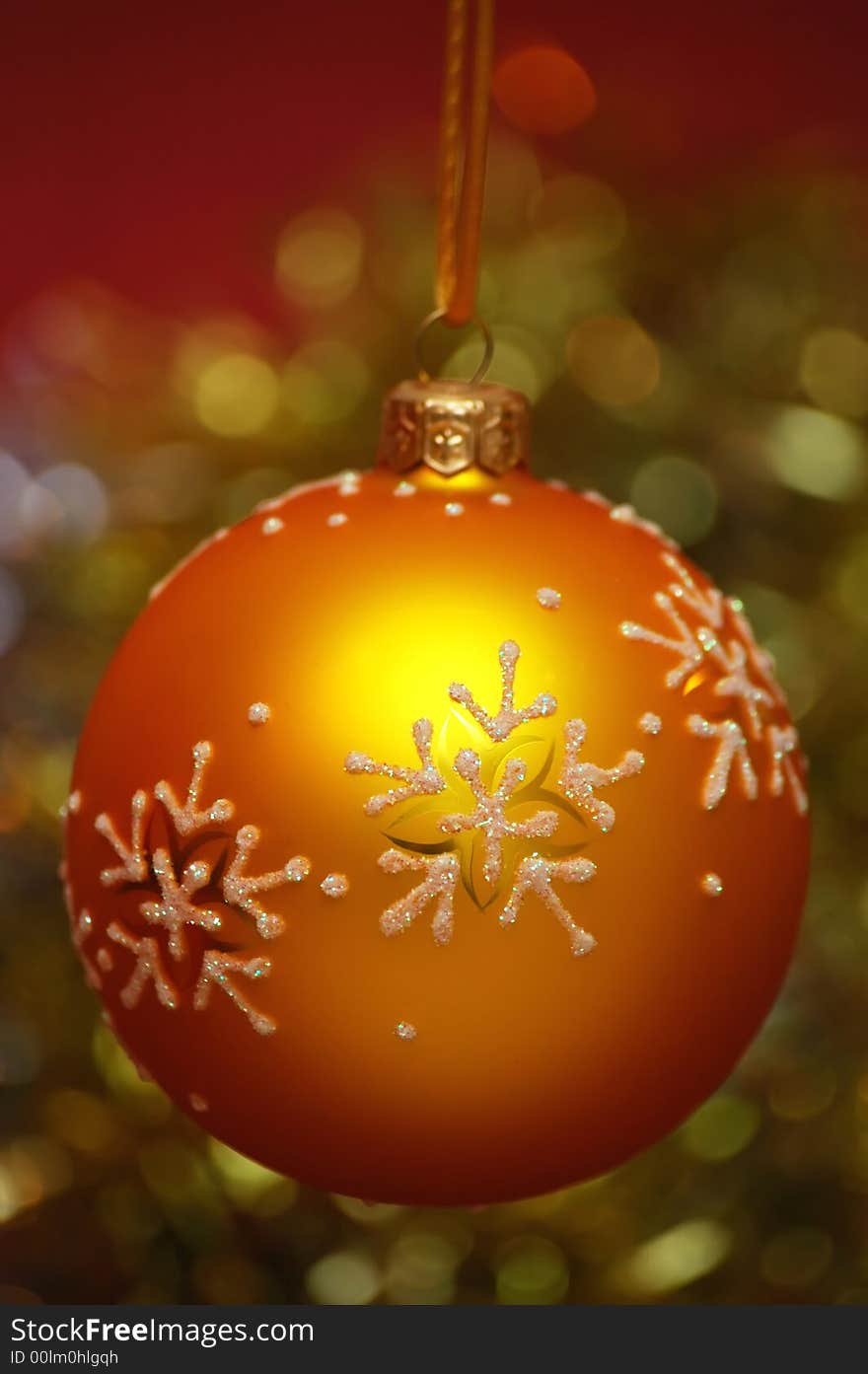 Yellow christmas ball on a colorful blur background