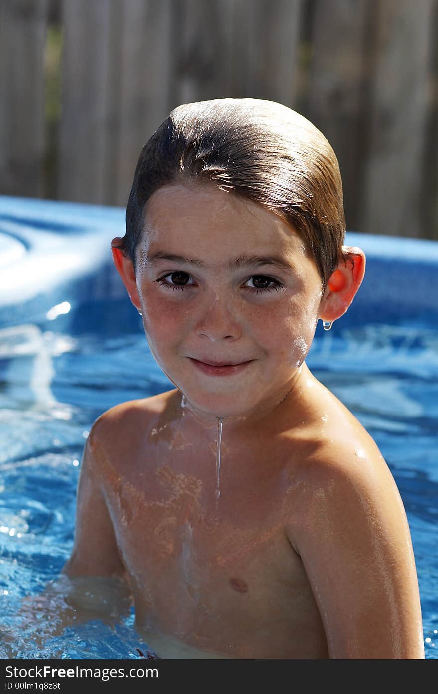 Cute young boy in pool smiling. Cute young boy in pool smiling